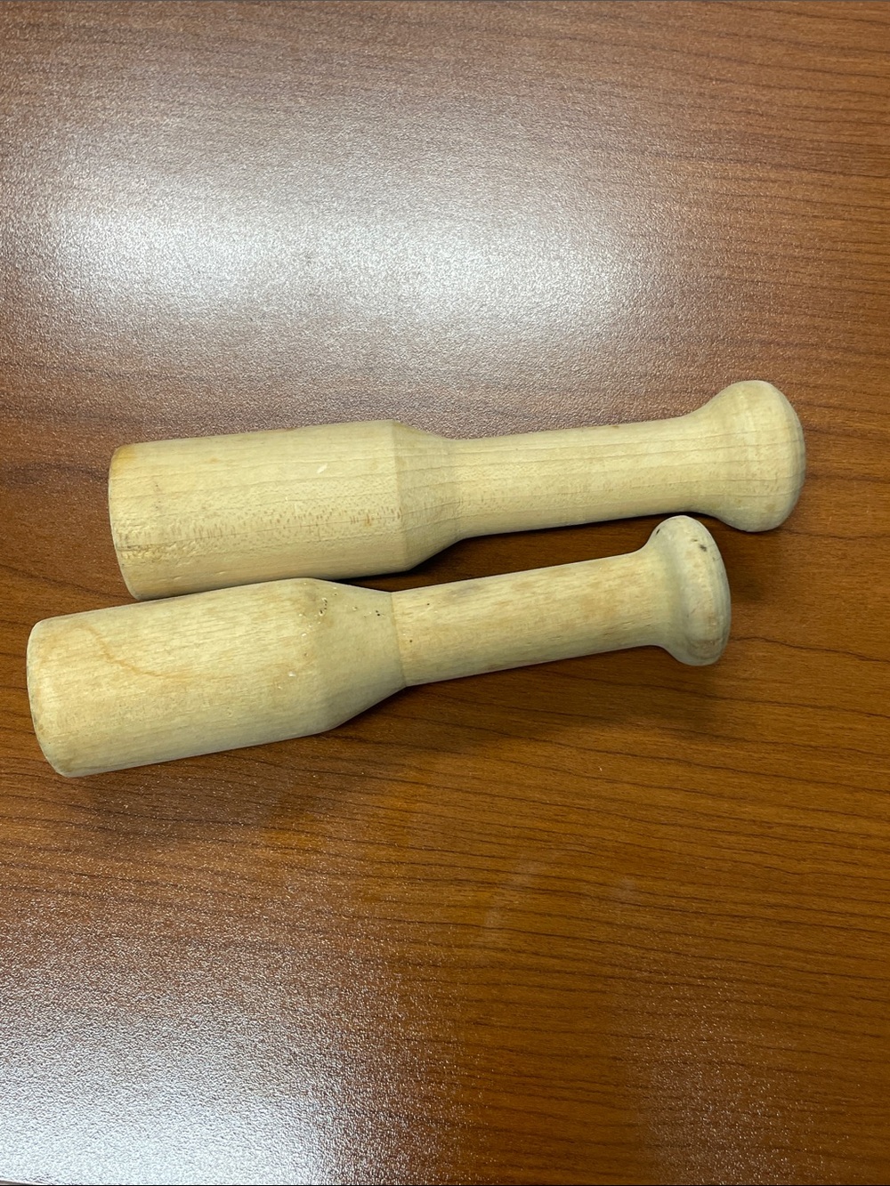 Two wooden pestles